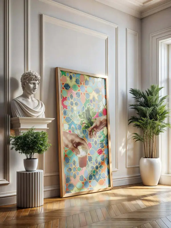 Une œuvre d’art encadrée vibrante et orientée verticalement présentant un motif de mosaïque coloré avec deux mains se tendant l’une vers l’autre sur un fond de formes géométriques dans des nuances de rose, bleu, vert et jaune.