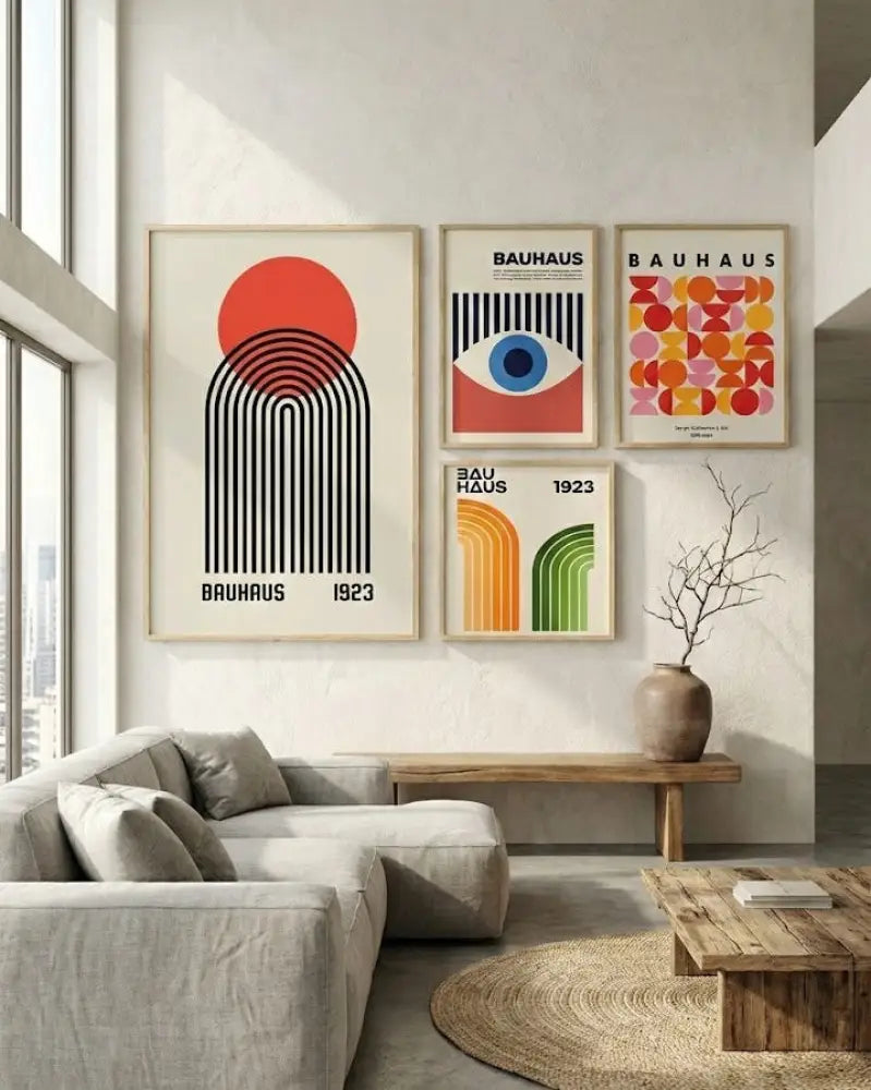 Ensemble de quatre impressions d’art encadrées sur le thème Bauhaus présentant des designs géométriques audacieux, des couleurs vives comme le rouge, l’orange, le bleu et le vert sur des fonds neutres.
