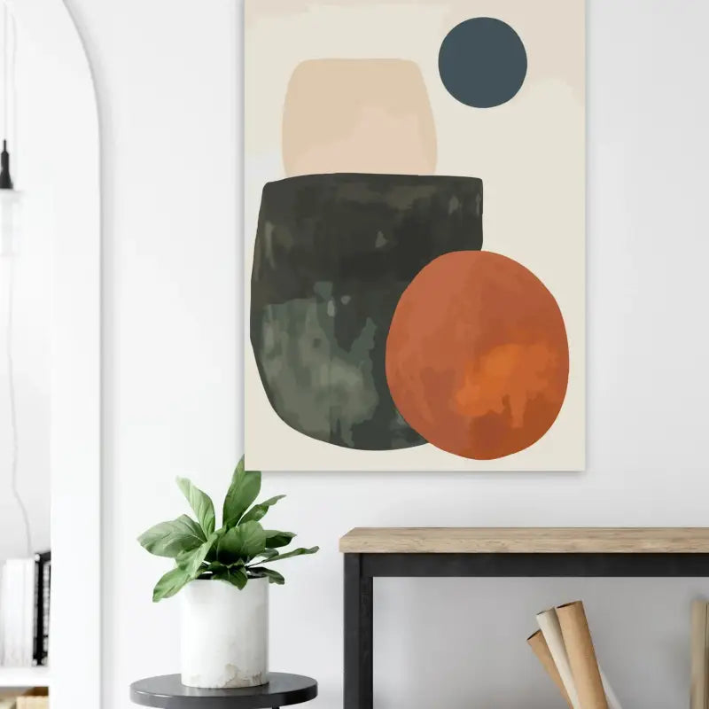 Art mural géométrique abstrait mettant en scène des formes superposées en tons beige sourd, gris foncé et orange chaud sur une toile crème clair.