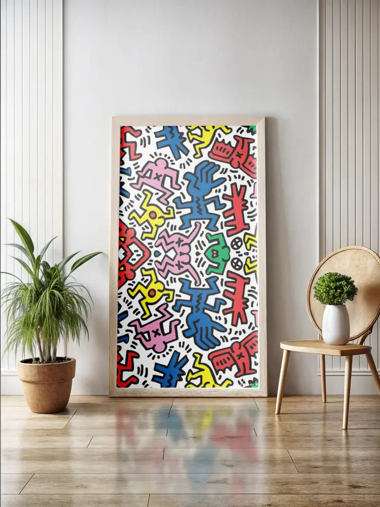 Une œuvre d’art encadrée vibrante mettant en scène des figures stylisées colorées en rouge, bleu, jaune et rose sur un fond blanc.