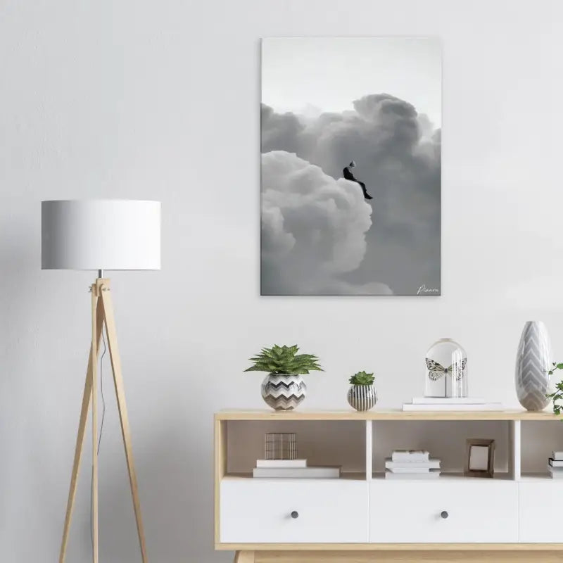 Impression abstraite sur toile gris et blanc représentant une figure solitaire assise sur des nuages volumineux.