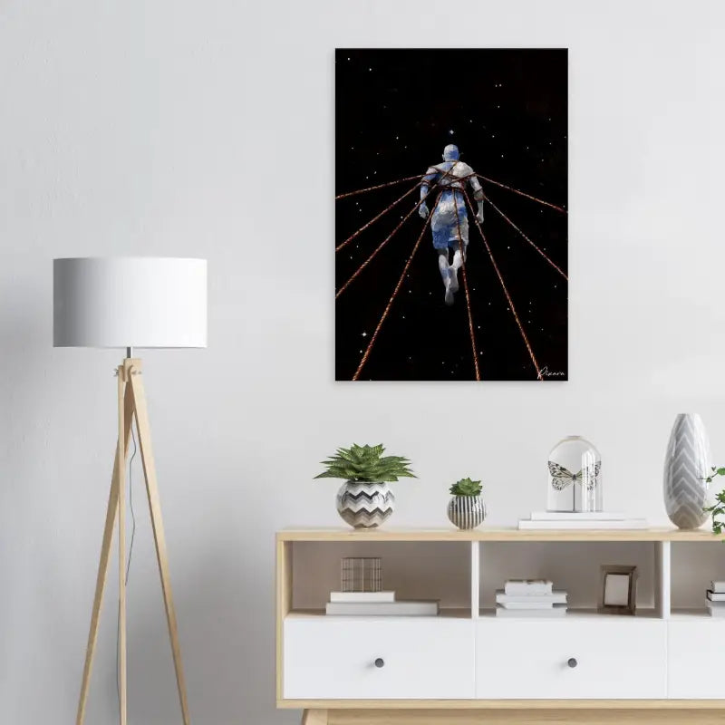Impression sur toile noire présentant une figure bleue suspendue dans l’espace, liée par des lignes rouges lumineuses sur un arrière-plan étoilé.