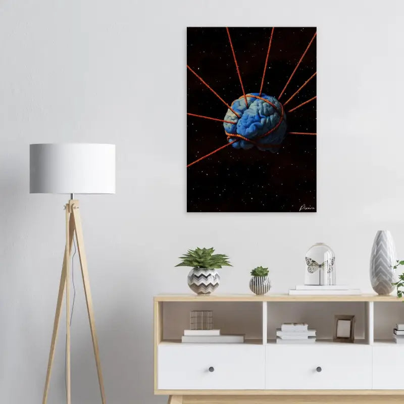 Une impression sur toile d’un cerveau bleu saisissant, enveloppée de cordes rouges et placée sur un fond noir étoilé.